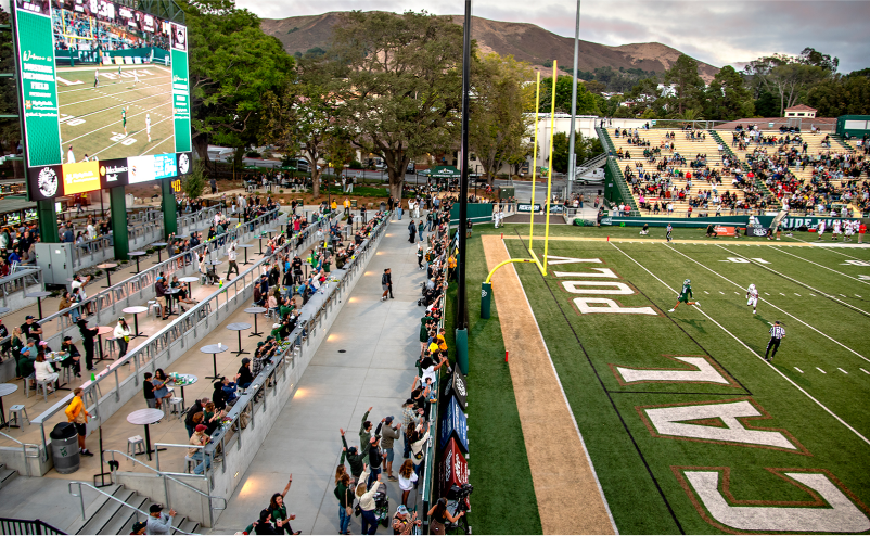 Cal Poly football stadium with fans watching the game from the Partners Plaza area and the grandstands.