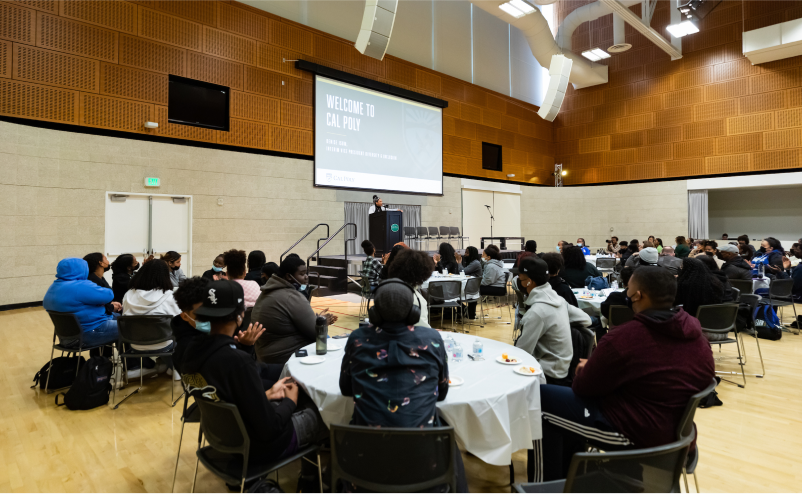 Welcome event inside Cal Poly's Multi-Activity Center with students seated at round tables.