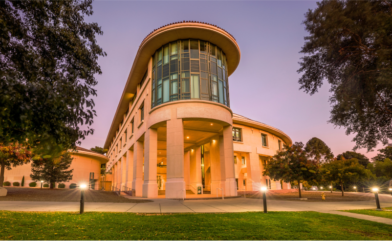 Exterior of the Orfalea College of Business rotunda building at Cal Poly during sunset.